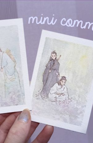 Hand holding two tiny watercolour paintings.